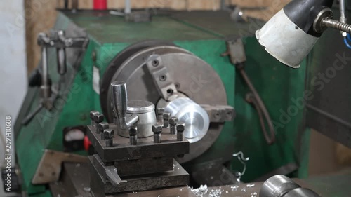 A lathe is installed in the production workshop. An electric lathe removes a layer from a metal workpiece, shaping it into a finished product. Production of metal products.