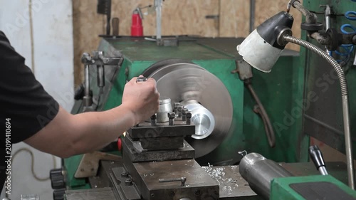 A lathe is installed in the production workshop. An electric lathe removes a layer from a metal workpiece, shaping it into a finished product. Production of metal products.