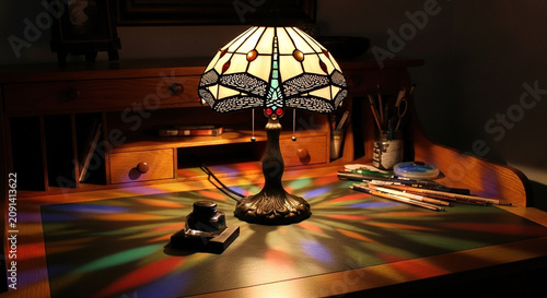 Stained Glass Lamp on a Wooden Desk with Drawing Supplies