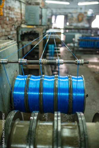 фотографія Industrial spools with blue plastic filament in a Bhavnagar factory