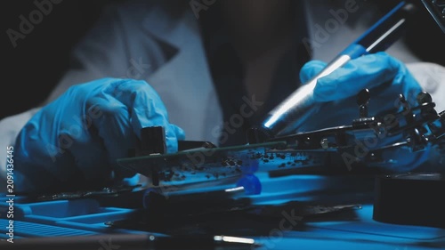 Engineer focuses intently on circuit board assembly