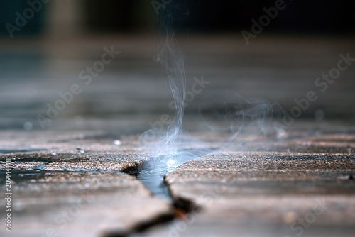 Smoke Rising from a Concrete Crack