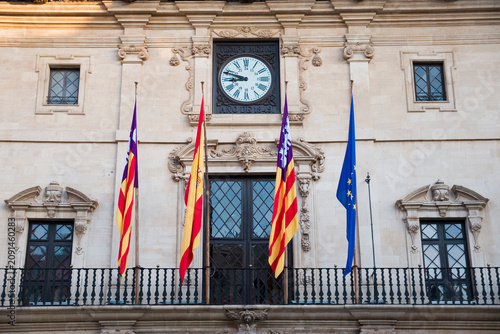 Close-up of Palma City Hall Clock and Flags