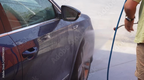 Pressure Washing Dark Blue Car Side Door Close Up at Car Wash
