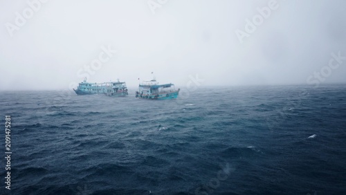 Fényképezés Boats battling a rough sea through a driving rainstorm and wind