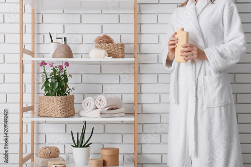 Woman in a white bathrobe h...