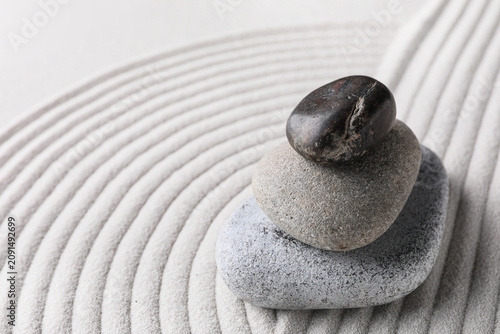 Canvas Print Stacked zen garden stones on raked sand, balance and harmony concept, spiritual