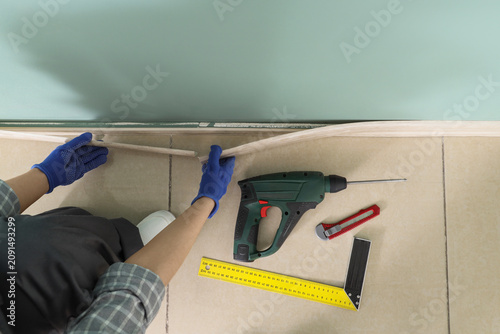 Female worker installing ba...