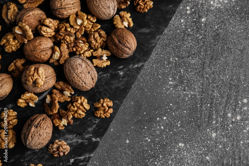 Board with walnuts on grey ...