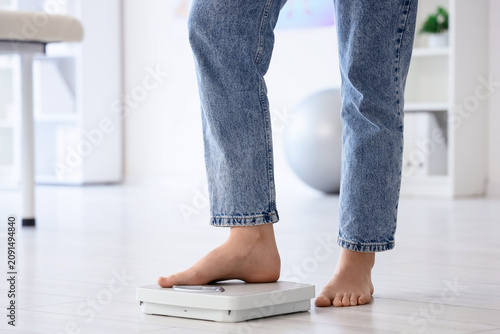 Legs of woman in jeans meas...