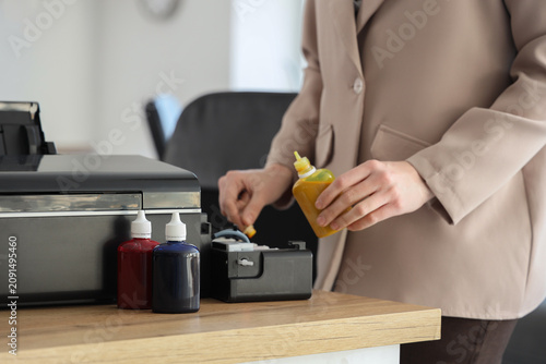 Young businesswoman pouring...