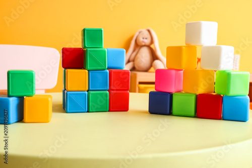 Fotografija Colorful cubes on table in childrens room, closeup