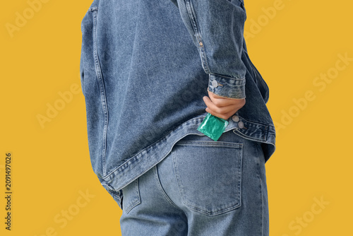 Young man putting condom in...