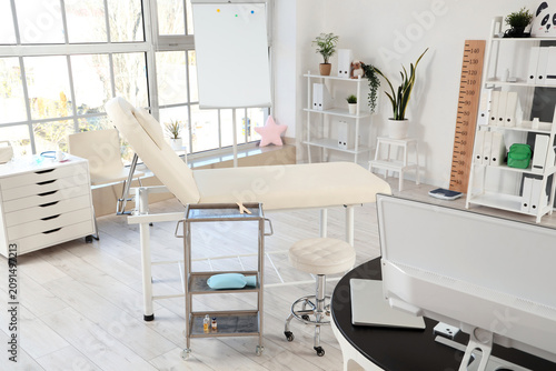 Interior of pediatricians office with couch and plants