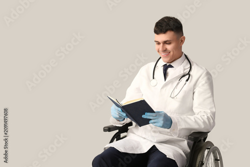 Young male doctor in wheelc...