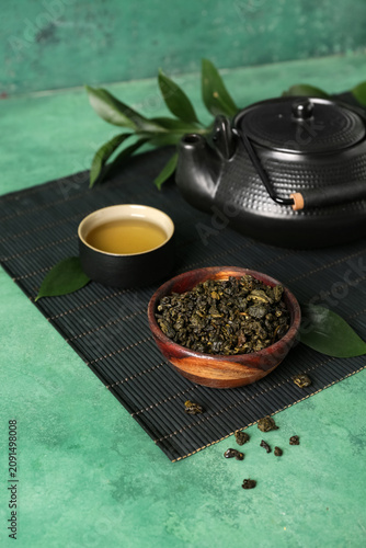 Bamboo mat with teapot, cup...
