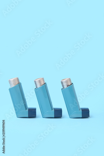 Asthma inhalers on blue bac...