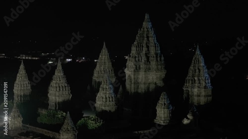 Night aerial drone footage of Prambanan Temple illuminated under the starry sky, Indonesia