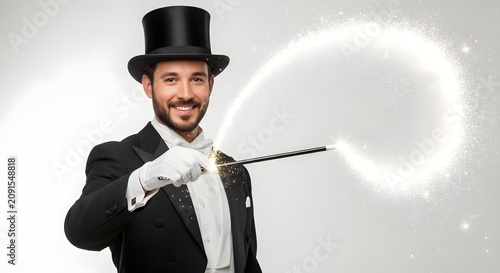 Obraz w ramie Magician in tuxedo performing magic with sparkling wand