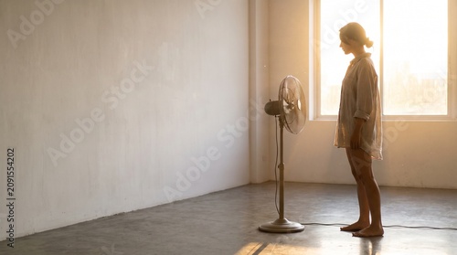 Side profile of person enjoying breeze from pedestal fan mockup