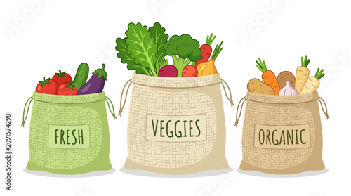 Organic vegetable bags with fresh garden produce in burlap sacks.