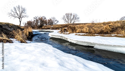 A winding waterway, partially frozen with ice, flows through a grassy and treed landscape, under a clear sky