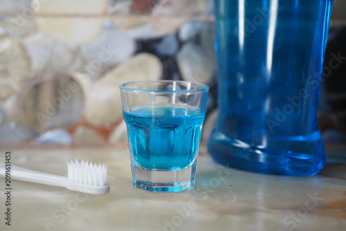 Принти на полотні mouthwash liquid and toothbrush on the counter