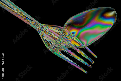 Bild auf Leinwand Plastic fork and spoon photographed with polarized light creating colourful stre