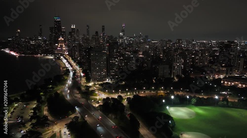 Breathtaking High Aerial Night View of Chicago Downtown and Lake Shore Lit Up with Traffic