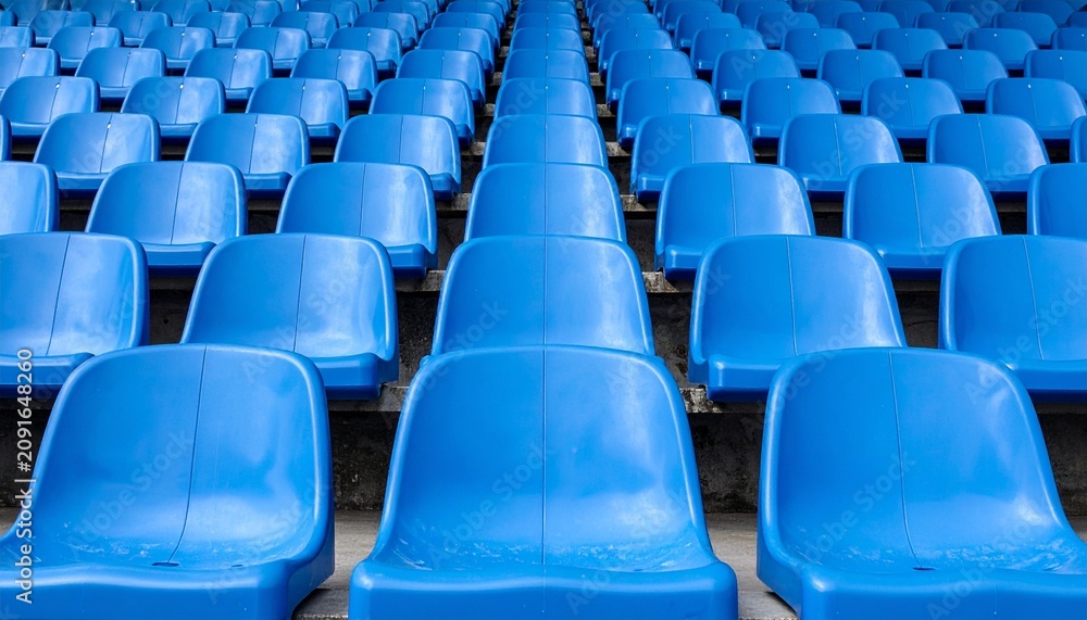 Obraz premium Rows of empty bright blue stadium seats arranged in a pattern creating a vibrant visual background for sports events and public gatherings.