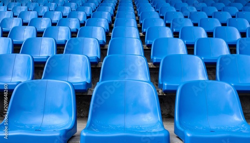 Rows of empty bright blue stadium seats arranged in a pattern creating a vibrant visual background for sports events and public gatherings.