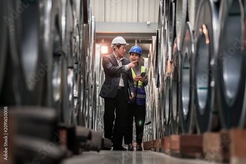 Industrial Technicians Discuss Steel Manufacture in Factory Setting
