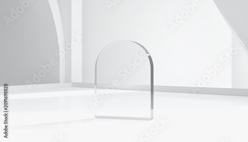 Clear glass arch shape on white reflective surface, minimalist studio lighting