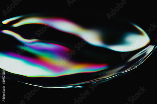 Futuristic digital graphic design featuring distorted metallic fluid waves with a grainy effect.