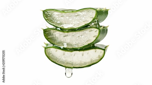 Stacked slices of fresh green aloe vera with dripping gel