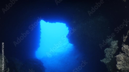 cave diving underwater scuba divers exploring caves and having fun ocean scenery sun beams and rays background