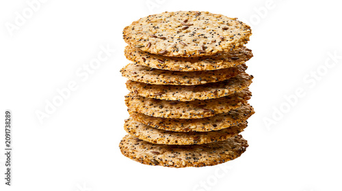 Bild auf Leinwand Stack of round multigrain crackers with visible seeds, isolated on transparent b