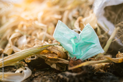 Obraz na plátně Used face mask discard in household garbage
