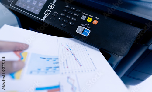 фотографія Office worker print paper on multifunction laser printer