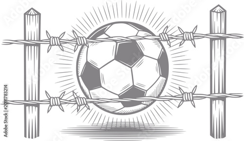 Fotografie Soccer ball behind barbed wire fence, symbolizing restriction and confinement