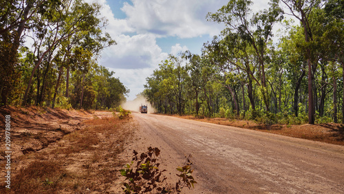 Truck kicking up dust on remote dirt road through bush, Cape York Peninsula, Far North Queensland, Australia
