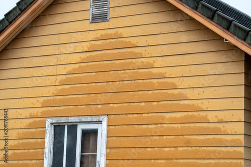 Canvas Print Rain blows against the artificial wood house walls