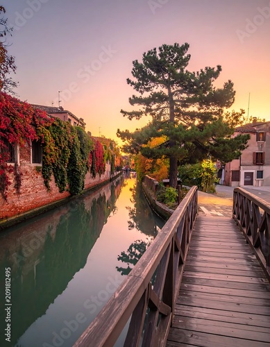 Serene Wooden Footbridge Over Quiet Canal at Sunset in Historic European Village