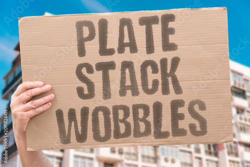 Fotografie "Plate Stack Wobbles" Dishes unstable in cupboard