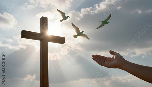 Christian cross against bright sunbeams with white doves of peace