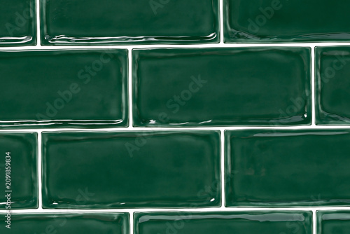 High gloss emerald green subway tile wall texture with white grout lines