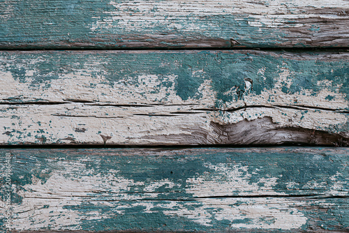 Vintage rustic wood planks background with dramatically peeling teal paint and visible grain texture