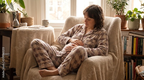 Pregnant woman relaxing in cozy living room with natural light