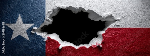 Texas flag showing through a hole in the wall with a rough texture