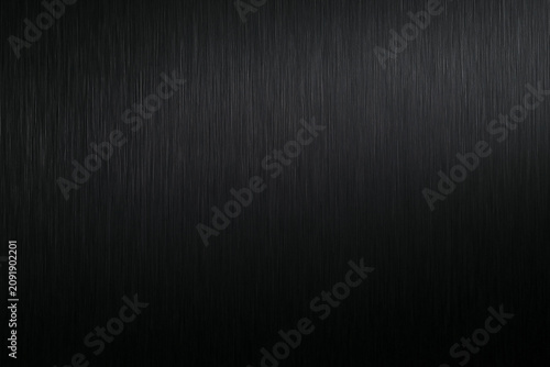 Vertical brushed dark metal surface with subtle lighting